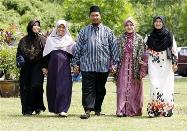 In this  Aug. 15, 2009 photo, polygamist Mohammad Inaamulillah Bin Ashaari, center, is shown with his four wives, from left, Rohaiza Esa, Ummu Habibah Raihaw , Nurul Azwa Mohd Ani,and Ummu Ammarah Asmis at the 